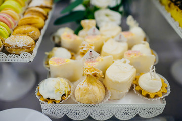 The different cakes stand on the buffet table