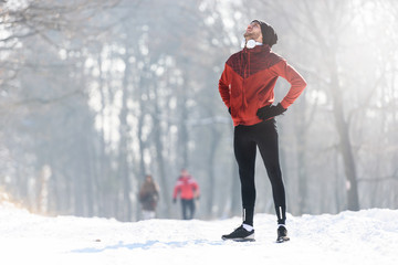 Man Sportsman Taking Break From Running in Extreme Snow Conditions