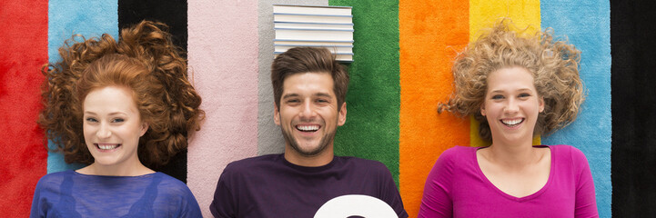 Smiling man and women at the colorful background