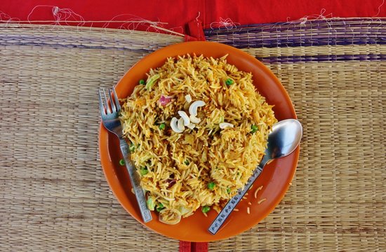 A Plate Of Vegetarian Rice Biryani With Cashews On Top