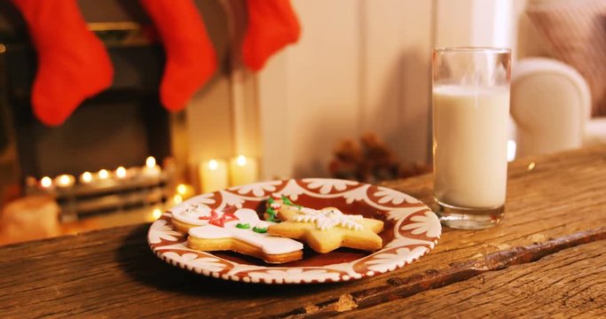 Gingerbread cookies with a glass of milk on wooden table during christmas time 4k