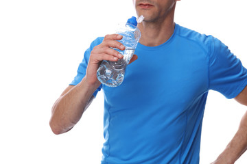 Fitness muscular man holding bottle of water after workout exercising. Rest after sport activity. Sport, recreation and healthy lifestyle concept