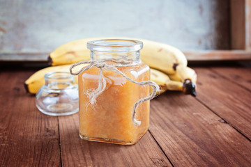 Bananas jam in a glass jar selective focus