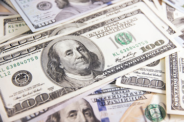 Fototapeta premium Many hundred dollar bills on wooden table