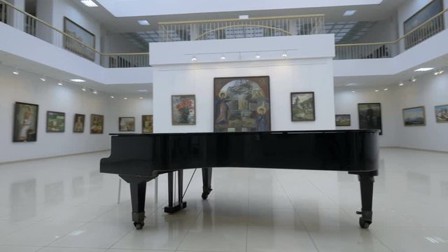 Grand piano in a concert hall. No people. Steadycam shot. 4K.