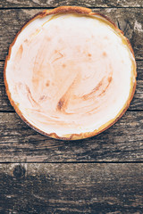 Homemade lemon pie on rustic wooden background.