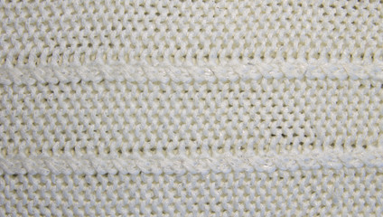 White knitted woolen texture. Knitted pattern