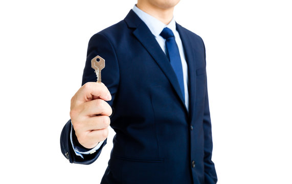 Businessman showing a key