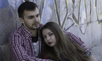 Young couple near graffiti wall. Love story