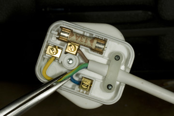 Wiring of a British three pin electrical plug.