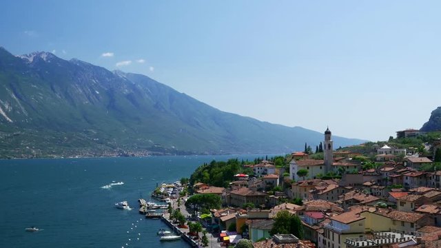 Aerial view of the Limone Sul Garda and Lago di Garda lake with zooming in motion, Northern Italian.