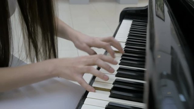 Pianist playing music. Piano keyboard close up. 4K