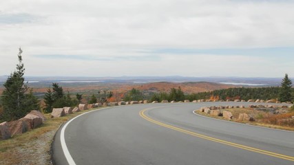 Pan of a portion of the Park Loop Road on Cadillac Mountain in Acadia National Park, Maine on an Autumn day.