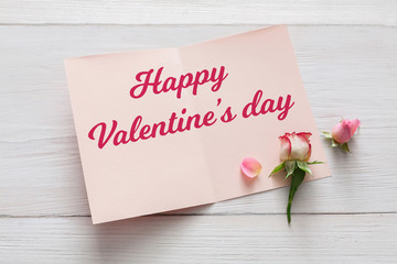 Happy Valentine day card background with flowers on white wood