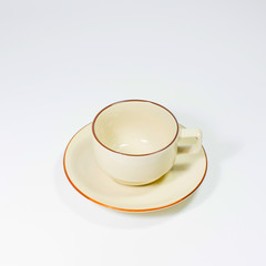 Isolated modern stylish white coffee cup or mug on a plate on a white background