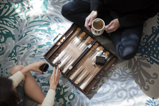 Overhead view of two people playing backgammon