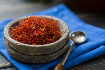 Raw Organic Red Saffron Spice in a clay bowl