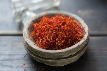 Raw Organic Red Saffron Spice in a clay bowl