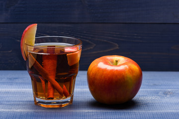glass with juice, pieces of apple, cinnamon, apple