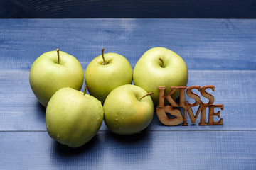 apples on blue vintage background with decorative lettering