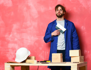 builder man holding putty knife