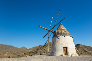 Traditional white windmill in San Jose. Natural Park of Cabo de Gata. Spain.