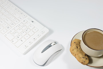 Office desk with  keyboard and coffee ,cookie cup