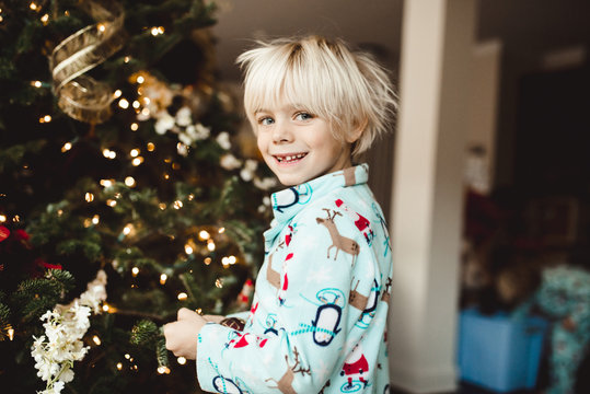 Young boy decorating christmas tree 
