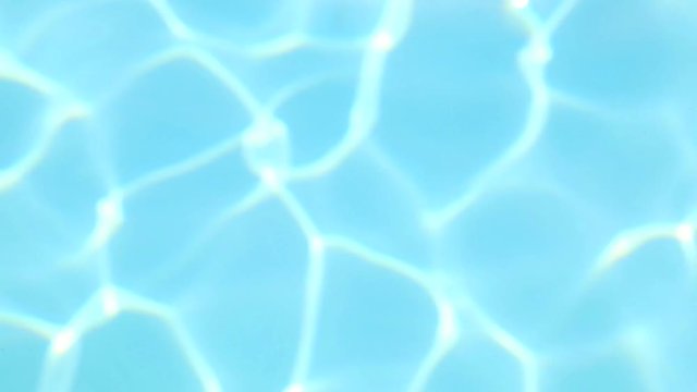 Blurry swimming pool blue water surface. Real time full hd video footage.
