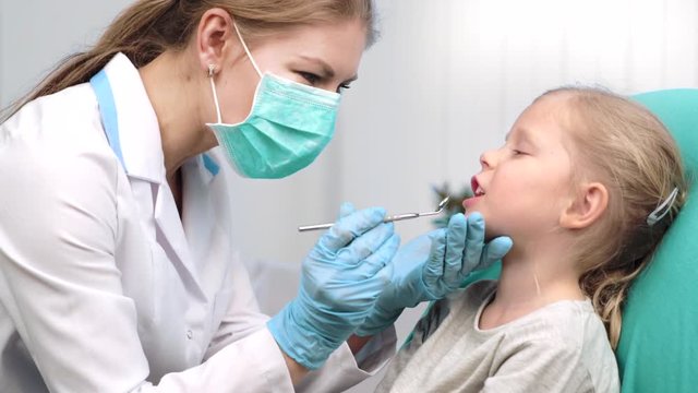 Teeth cure and inspection. Girl patient visiting dentist in dental clinic. 