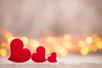 Red hearts on the wooden background.