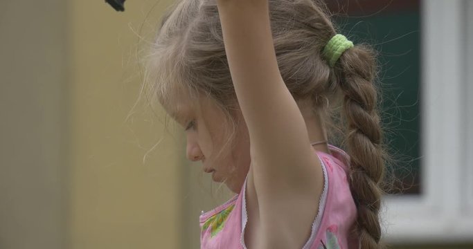 Small Fair-Haired Girl Has Hung on a Bars