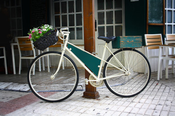 Fototapeta na wymiar vintage Bicycle with basket of flowers