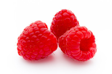 Ripe red raspberries isolated on white background.