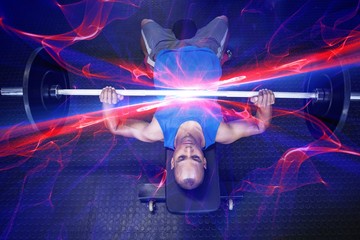 High angle view of man doing bench press with barbell 