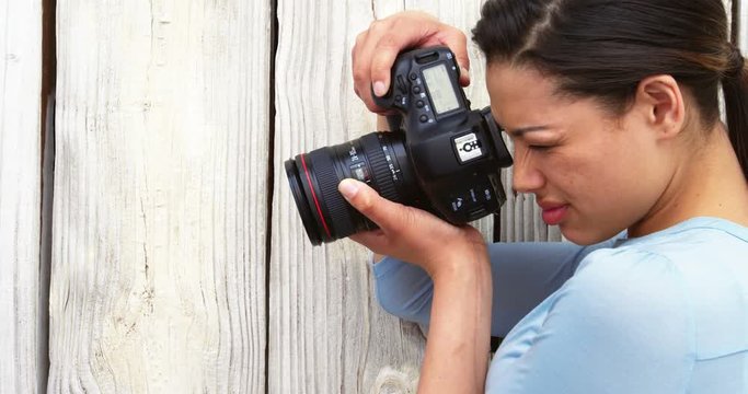 Photographer taking photo with digital camera in studio 4k