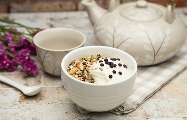 Granola served with coffee,milk,fruits