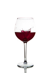 Red wine splashing in glass on a white background
