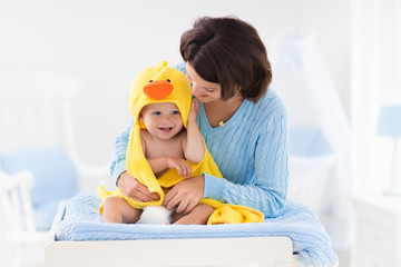 Mother and baby in towel after bath