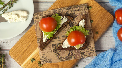 Healthy Snacks Sandwiches with goat cheese, salad, cherry tomatoes. Instagram style top view