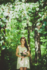 Fashion gorgeous young blonde woman in beautiful white dress in a fairy-tale forest. magic atmosphere