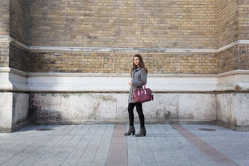 Young woman posing outdoors and smiling