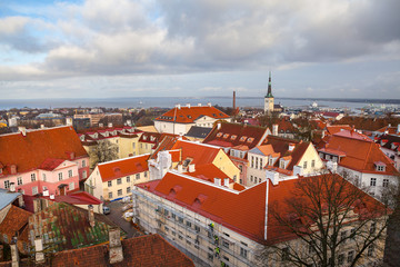 Obraz premium View from Tallinn Toompea hill to downtown with St. Olafs church, towers and red roofs of the historical city center