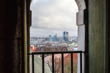 Modern skyscapers of Tallinn in a window of the medieval Dome church