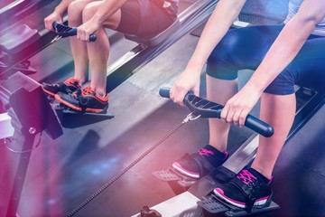 Mid section of people exercising on rowing machine