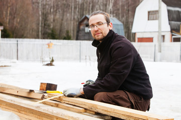 Man sawing a log handsaw
