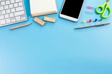 Office table with notebook, computer keyboard and smartphone. copy space