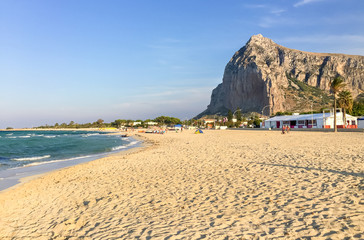 Tourists enjoy mediterranean sea in famous  San Vito Lo Capo beach.
