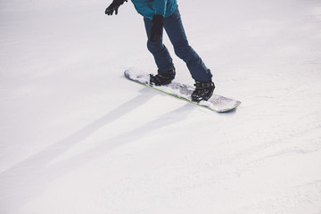 Woman snowboarder on the slopes of the resort on a winter day.