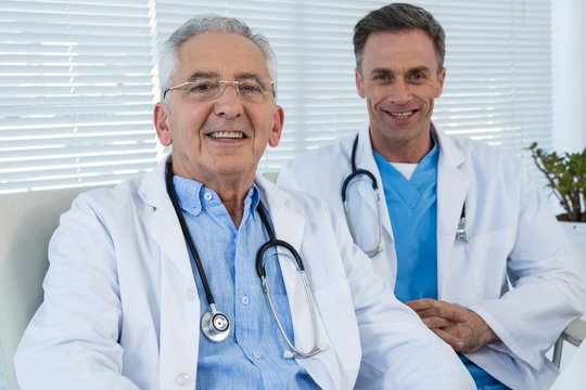 Portrait of smiling doctors sitting at table